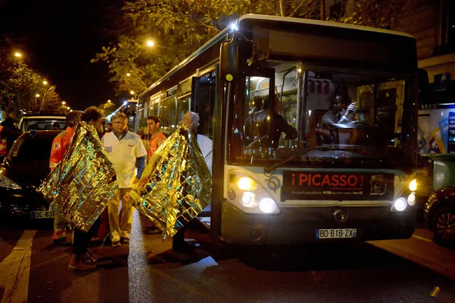 Survivors board a bus after gunfire in the Bataclan concert hall on November 13, 2015 in Paris, France. (Photo by Antoine Antoniol/Getty Images)