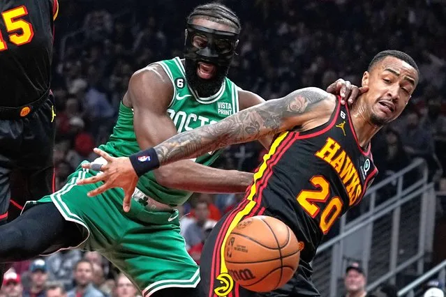 John Collins (20) fights for the rebound against Boston Celtics' Jaylen Brown (7) during the first half of Game 6 of a first-round NBA basketball playoff series, Thursday, April 27, 2023, in Atlanta. (Photo by Brynn Anderson/AP Photo)