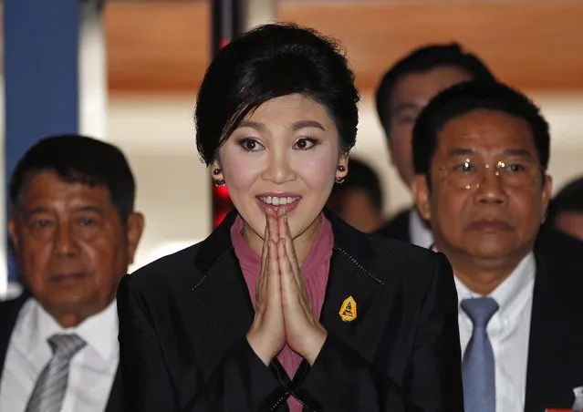 Ousted former Prime Minister Yingluck Shinawatra gestures as she arrives at Parliament before the National Legislative Assembly meeting in Bangkok January 9, 2015. Thailand's legislature begins a hearing against Yingluck on Friday over the rice subsidy scheme that critics denounced as a wasteful handout to her supporters. (Photo by Chaiwat Subprasom/Reuters)