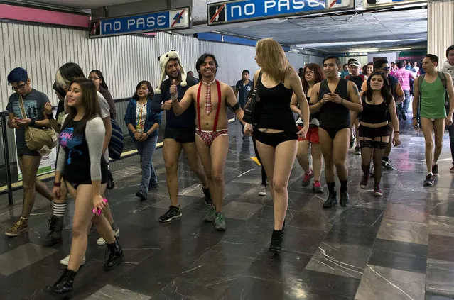 People walk through a subway station during the worldwide “No Pants Subway Ride” event in Mexico City on January 11, 2015. (Photo by Ronaldo Schemidt/AFP Photo)