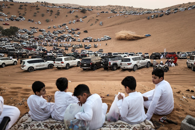 People gather and watch as drifters perform in the desert of Umm Al Quwain in the United Arab Emirates, on December 1, 2025. (Photo by Fadel Senna/AFP via Getty Images)