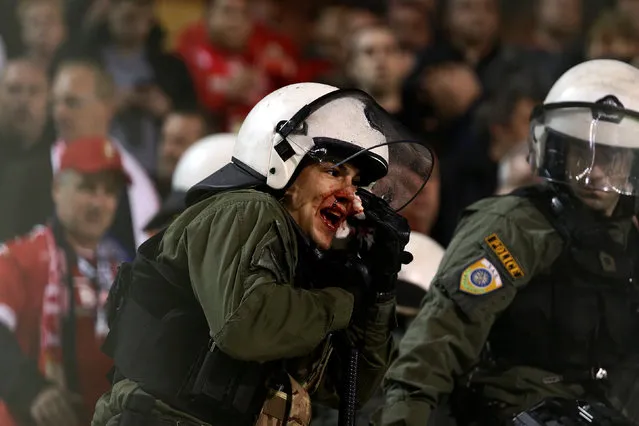 Football Soccer, Panathinaikos vs Standard Liege, Europa League Group Stage, Apostolos Nikolaidis stadium, Athens, Greece on November 3, 2016. An injured riot police officer reacts during clashes with Standard Liege fans. (Photo by Alkis Konstantinidis/Reuters)