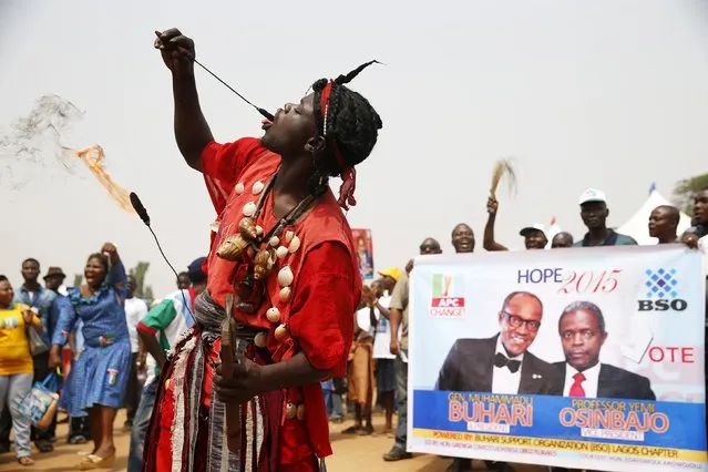 A reveller performs at the flag-off campaign for All Progressives Congress (APC) governorship candidate Akinwunmi Ambode in Lagos, January 14, 2015. (Photo by Akintunde Akinleye/Reuters)