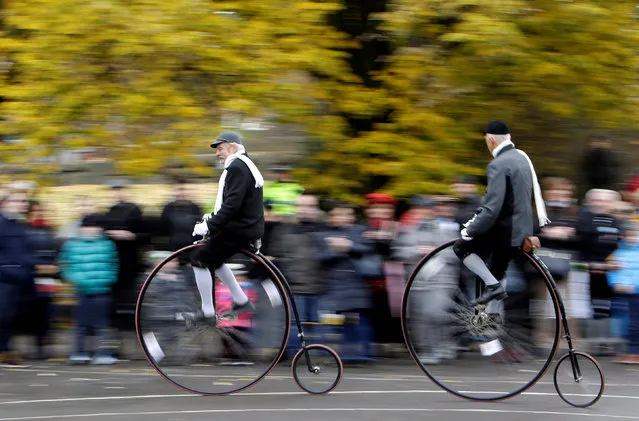 Participants wearing historical costumes ride their high-wheel bicycles during the annual penny farthing race in Prague, Czech Republic November 5, 2016. (Photo by David W. Cerny/Reuters)