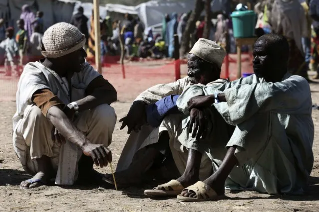 Men who have fled violence in Nigeria sit on the ground at a refugee welcoming center in Ngouboua, Chad, January 19, 2015. (Photo by Emmanuel Braun/Reuters)