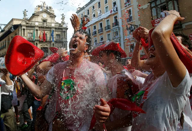 Revellers are splashed with water before the opening of the San Fermin festival in Pamplona, Spain, July 6, 2018. (Photo by Joseba Etxaburu/Reuters)