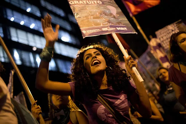 Pro-choice activists show support for the legalization of abortion in Argentina where lawmakers are debating the issue, as they march in Rio de Janeiro, Brazil, Wednesday, August 8, 2018. Abortion is illegal in Brazil, except when a woman's life is at risk, when she has been raped or when the fetus has a usually fatal brain abnormality called anencephaly. (Photo by Silvia Izquierdo/AP Photo)