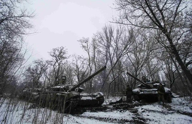 Pro-Russian separatists stand next to tanks on the outskirts of Horlivka, eastern Ukraine February 10, 2015. (Photo by Maxim Shemetov/Reuters)