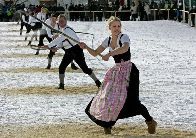 A woman participates with a men's team during the traditional whip-cracking contest in  the Bavarian town of Schoenram, Germany, Sunday February 8, 2015. (Photo by Diether Endlicher/AP Photo/DPA)