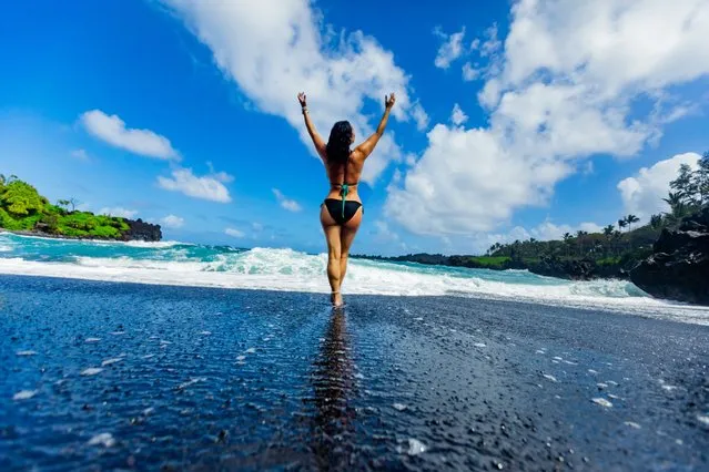 Woman enjoying the sun on one of Maui's black sand beaches, Hawaii, United States of America, North America on February 25, 2022. (Photo by Laura Grier/Robert Harding RF via AFP Photo)