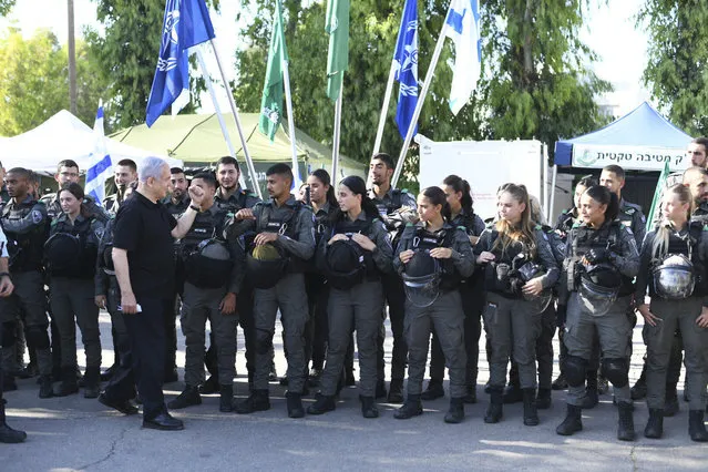 Israeli Prime Minister Benjamin Netanyahu meets with Israeli border police on Thursday, May 13, 2021 in Lod, near Tel Aviv after a wave of violence in the city the night before.  Jewish and Arab mobs battled in the central city of Lod, the epicenter of the troubles, despite a state of emergency and nighttime curfew. (Photo by Yuval Chen, Yediot Ahronot, Pool via AP Photo)