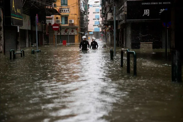 Rescue workers make their way through floodwaters during a rescue operation during Super Typhoon Mangkhut in Macau on September 16, 2018. (Photo by Isaac Lawrence/AFP Photo)