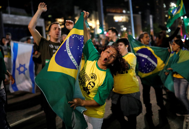 Supporters of Jair Bolsonaro react after polls closed in Sao Paulo, Brazil on October 28, 2018. (Photo by Nacho Doce/Reuters)