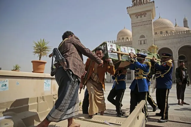 In this March 2, 2021 file photo, honor guards and armed Houthi fighters carry a coffin of a Houthi rebel fighter who was killed in recent fighting with forces of Yemen's internationally recognized government during his funeral procession in Sanaa, Yemen. (Photo by Hani Mohammed/AP Photo/File)