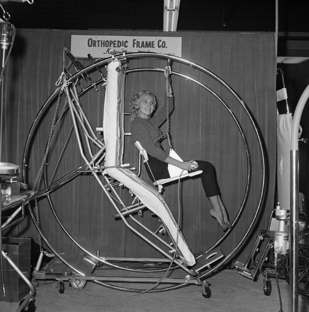 A new hospital bed, called the Stryker CircOlectric Universal bed, designed for more comfortable positions for the hospital patient, is modeled by Jo Marie Smith at the Annual Clinical Congress of the American College of Surgeons in San Francisco, October 18, 1960. The hoops serve as a built-in overhead frame for the attachment of traction apparatus available as accessories for the bed. They act as grasping and exercise bars for the recuperating patient. Power is supplied by a 1/3 horsepower motor. (Photo by Clarence Hamm/AP Photo)