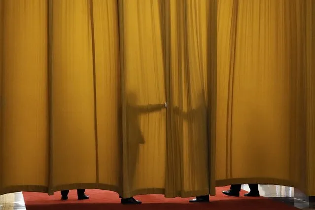 Guards keep a curtain closed prior to a meeting between France's President Emmanuel Macron and Chinese Premier Li Qiang at the Great Hall of the People, in Beijing, China, Thursday, April 6, 2023. (Photo by Thibault Camus/Pool via AP Photo)