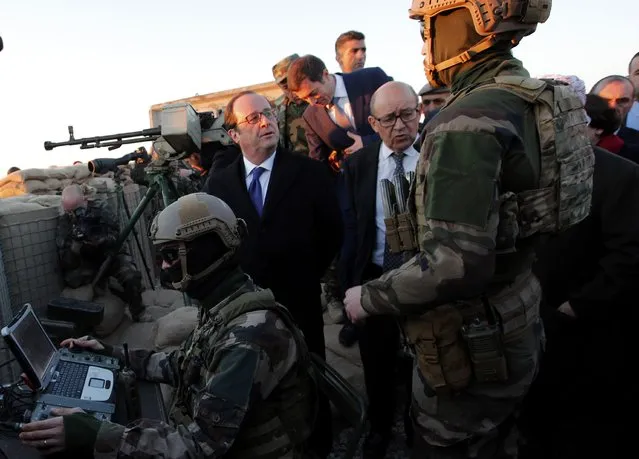 French President Francois Hollande (L) and French defense minister Jean-Yves Le Drian (R) meet with French soldiers as they visit a military outpost on the outskirts of Islamic State-held city of Mosul, outside the Kurdish city of Erbil, Iraq, January 2, 2017. (Photo by Christophe Ena/Reuters)