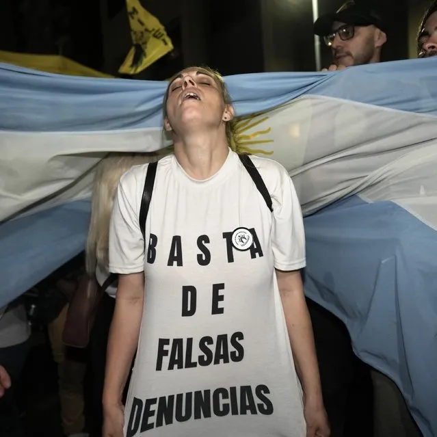 A supporter of presidential hopeful Javier Milei wears a shirt that reads in Spanish “Stop the false complaints” outside his campaign headquarters after polls closed for general elections in Buenos Aires, Argentina, Sunday, October 22, 2023. Milei has gone from being a television talking head that garnered high ratings with his unrestrained outbursts against the "political caste" that he blamed for Argentina's perennial economic woes to a frontrunner for the presidency.A presidential runoff election is set for Nov. 19. (Photo by Rodrigo Abd/AP Photo)