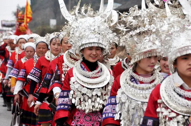 Ethnic Miao people wearing traditional costumes parade during Chinese Lunar New Year celebrations, in Taijiang county, Guizhou province, in this picture taken February 11, 2016. (Photo by Reuters/Stringer)