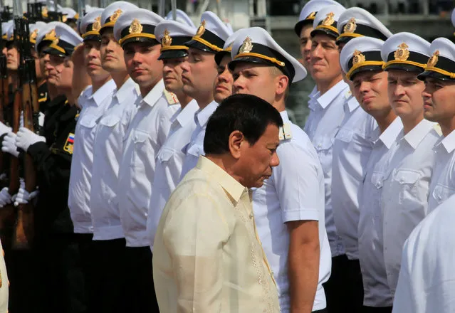 Philippine President Rodrigo Duterte walks past members of the Russian Navy upon his arrival to tour the Russian Navy vessel Admiral Tributs, a large anti-submarine ship, docked at the south harbour port area in metro Manila, Philippines January 6, 2017. (Photo by Romeo Ranoco/Reuters)