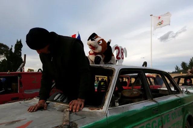A driver climbs into his car to take part in a demolition derby organised by the Malta Motor Sports Association to raise funds for charity in Ta' Qali, outside Valletta, Malta, January 8, 2017. (Photo by Darrin Zammit Lupi/Reuters)