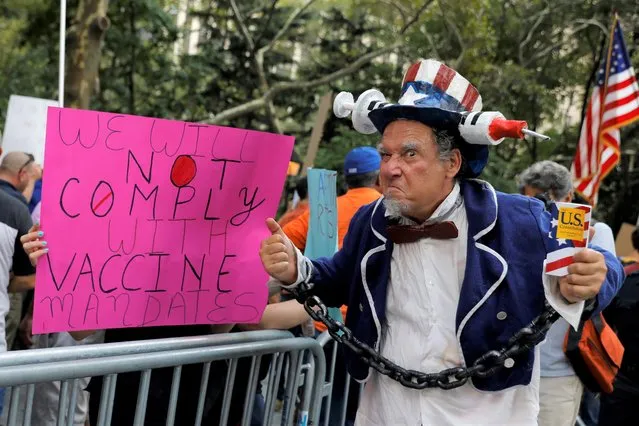 A person dressed as Uncle Sam poses during a protest against mandated coronavirus disease (COVID-19) vaccines and vaccine passports at City Hall in Manhattan, New York City, U.S., August 25, 2021. (Photo by Andrew Kelly/Reuters)