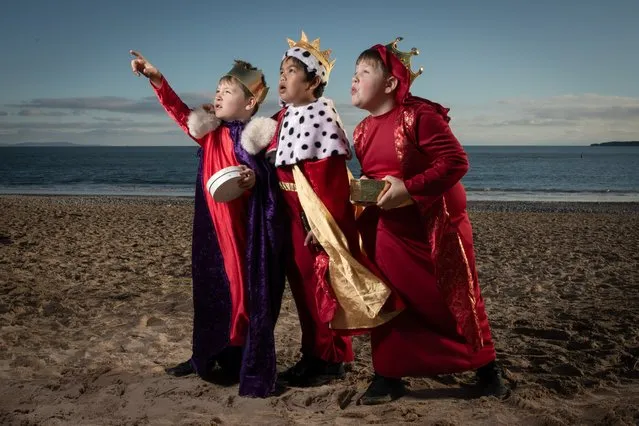 Pupils from St Teilo’s Catholic Primary School in Tenby, South Wales, perform a scene from their Nativity play in the second decade of December 2023. The three kings, played by Jack Rigby, Santos Basilnomo and Tommy Leggett, pretended to follow a star on South Beach, a stone’s throw from the school. (Photo by Joann Randles/Cover Images)