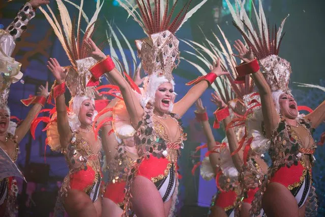 Dancers perform on the main stage in the Battle of the Troops contest during carnival celebrations in Santa Cruz de Tenerife, on the Spanish Canary island of Tenerife, on February 23, 2019. The over month-long event began on February 1st and finishes on March 10th with orchestras playing Caribbean and Brazilian rhythms throughout the festivities that range from the election of the Carnival Queen, the Junior Queen and the Senior Queen, children and adult murgas (satirical street bands), comparsas (dance groups) to performances on the streets. (Photo by Desiree Martin/AFP Photo)