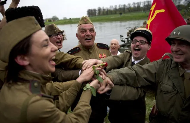 Members of a historical re-enactment group dressed as U.S. and Soviet Army soldiers take part in Elbe Day celebrations, in eastern German city of Torgau at the river Elbe, April 25, 2015. (Photo by Stefanie Loos/Reuters)