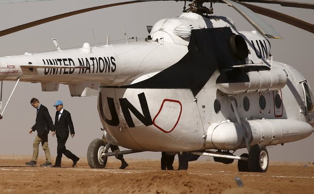 U.N. Secretary General Ban Ki-moon (R) walks out the helicopter as he arrives for a one day visit to the indigenous Sahrawi refugee camp  of Al Smara in Tindouf, southern Algeria March 5, 2016. (Photo by Zohra Bensemra/Reuters)
