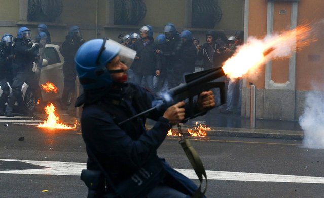 A policeman fires tear gas during a rally against Expo 2015 in Milan, Italy, May 1, 2015. (Photo by Stefano Rellandini/Reuters)