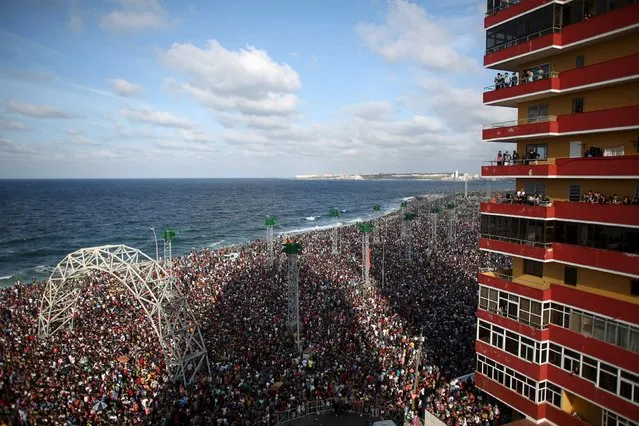 People at the seafront Malecon watch a performance by U.S. electronic music group Major Lazer in Havana, March 6, 2016. (Photo by Alexandre Meneghini/Reuters)