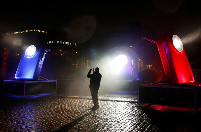 A man takes pictures of giant flashlights displayed along the Brussels' canal district during the Bright Brussels Festival in Brussels, Belgium February 4, 2017. (Photo by Francois Lenoir/Reuters)