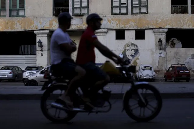People ride on a motorcycle in Havana, March 16, 2016. (Photo by Ueslei Marcelino/Reuters)