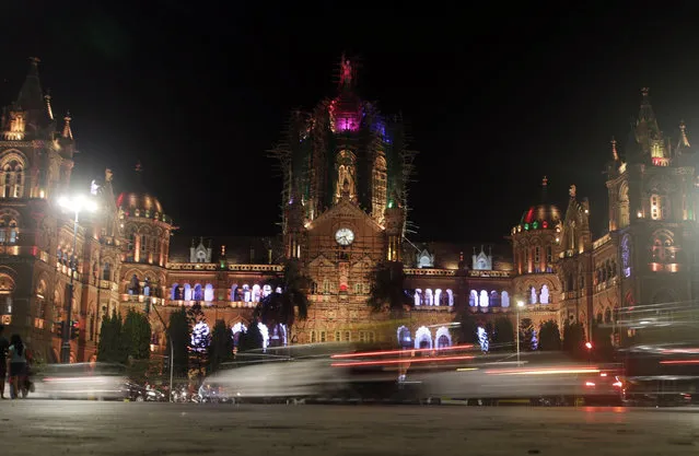 Mumbai's historic railway station Chhatrapati Shivaji Maharaj Terminus is seen before the lights were switched off for Earth Hour, in Mumbai, India, Saturday, March 30, 2019. Earth Hour takes place worldwide and is a global call to turn off lights for 60 minutes in a bid to highlight the global climate change. (Photo by Rajanish Kakade/AP Photo)