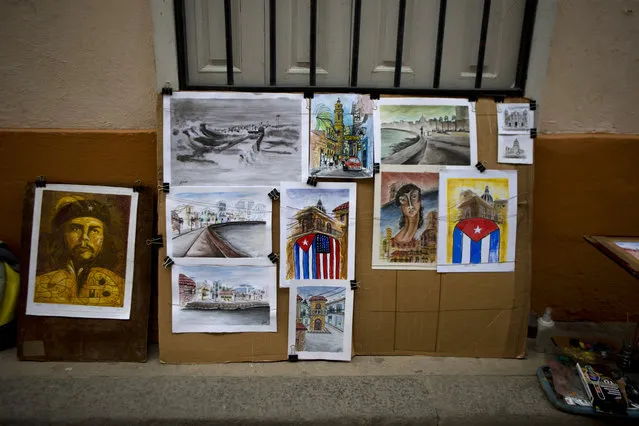 An artwork featuring side-by-side Cuban and American national flags is displayed at the street stand of artist Yaset Martin Hernandez in Old Havana, Cuba, Saturday, March 19, 2016. (Photo by Rebecca Blackwell/AP Photo)