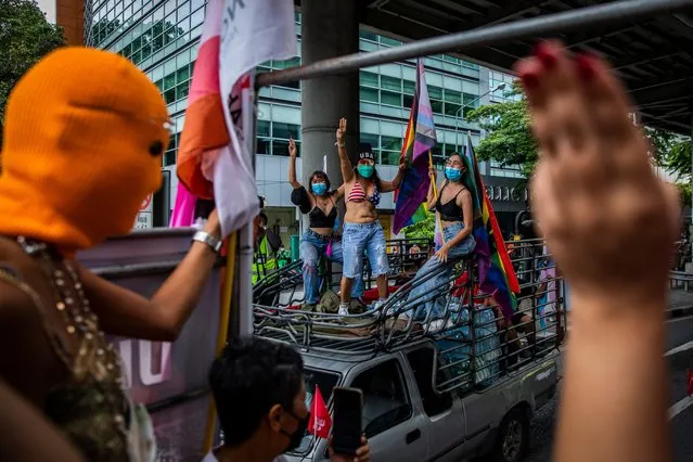 Members of the Feminist Liberation Front show a three-fingered salute during a “car mob” rally from Silom Road to Democracy Monument on October 9, 2021 in Bangkok, Thailand. The Feminist's Liberation Front is a democratic reform group focused on promoting gender equality and LGBTQ rights in Thailand. While raising awareness of issues such as marriage equality, gender-based violence, and oppression, the speakers at rally's organized by the Feminist Liberation Front also call for institutional reform and the repeal of Section 112, a criminal code in Thailand's lese majeste laws which carry up to 15 years in prison. Under the leadership of Chumaporn “Waaddao” Taengkliang, the Feminist Liberation Front acts as a safe space for feminists, members of the LGBTQ community, activists and allies while maintaining peaceful, colorful protests promoting inclusivity and human rights. While globally Thailand is considered an inclusive country for LGBTQ+ communities and tourists, those living here struggle for equal rights as courts continue to postpone rulings in a groundbreaking LGBTQ+ marriage equality case. (Photo by Lauren DeCicca/Getty Images)