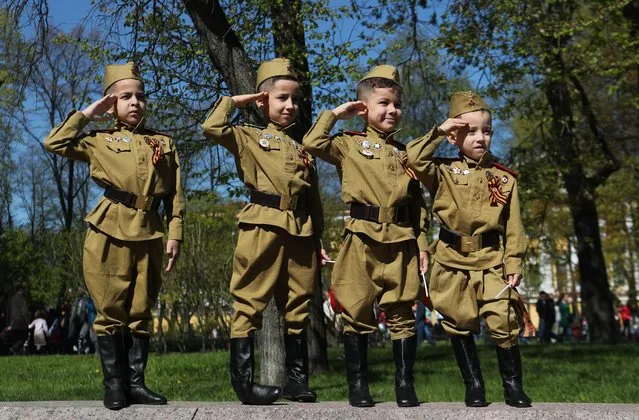 Children in uniforms salute during the Victory Day celebrations, which marks the anniversary of the victory over Nazi Germany in World War Two, in St. Petersburg, Russia on May 9, 2019. (Photo by Anton Vaganov/Reuters)