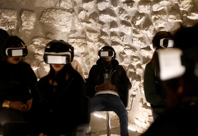 Visitors wear headsets as they experience a virtual reality tour depicting Jerusalem as it was two millennia ago, at a visitors center near some of the world's most sacred sites holy to Jews, Muslims and Christians, in Jerusalem's Old City February 20, 2017. (Photo by Ronen Zvulun/Reuters)