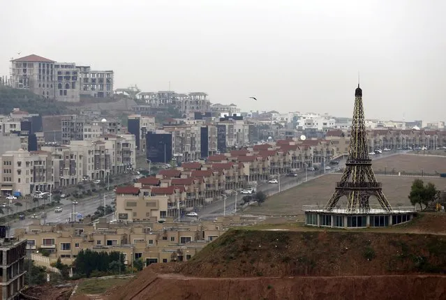 A replica of the Eiffel Tower is seen on a hill in an area being developed in Bahria Town on the outskirts of Islamabad, Pakistan March 16, 2016. (Photo by Caren Firouz/Reuters)