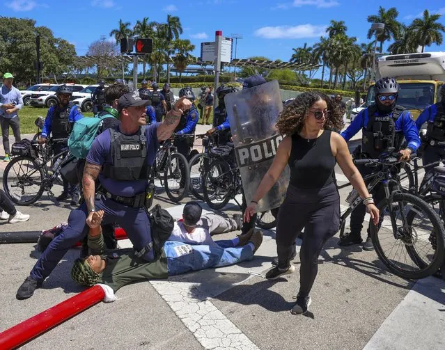 Protesters for a cease-fire in support of Gaza lie down in the intersection of NE 3rd Street and northbound Biscayne Boulevard and were later arrested by Miami Police, Monday, April 15, 2024, in downtown Miami. (Photo by Carl Juste/Miami Herald via AP Photo)