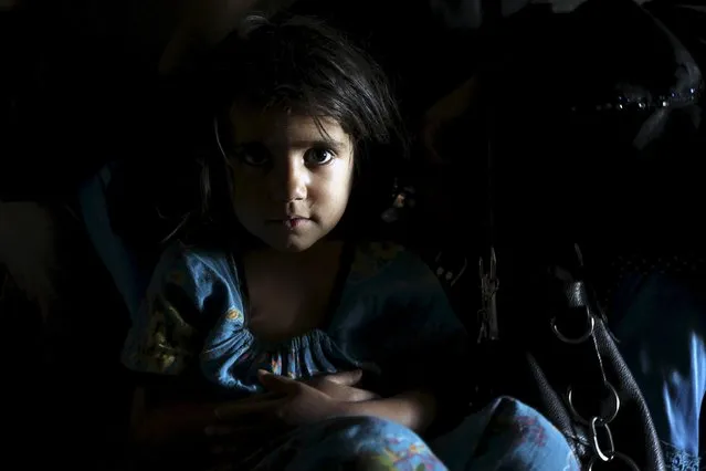 A girl looks on while resting on her mother's lap as they sit inside an underground water tunnel with other displaced Yemeni families, after they were forced to flee their home due to ongoing air-strikes carried out by the Saudi-led coalition in Sanaa May 2, 2015. (Photo by Mohamed al-Sayaghi/Reuters)