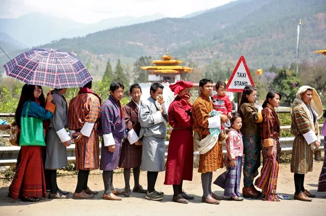 People wait in line to enter the Punakha Dzong, Bhutan, April 17, 2016. (Photo by Cathal McNaughton/Reuters)