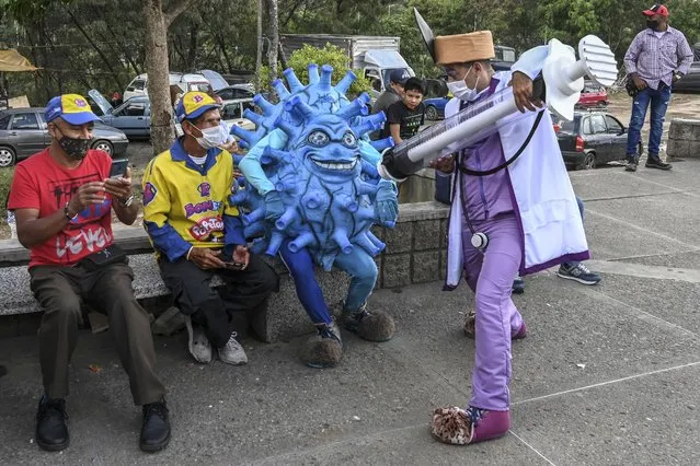 Artists perform during a campaign to promote vaccination against COVID-19 amid the novel coronavirus pandemic, in Medellin, Colombia, on February 19, 2021. (Photo by Joaquin Sarmiento/AFP Photo)