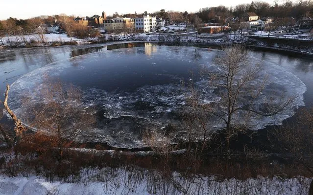 The Westbrook ice disk has returned to the Presumpscot River below Saccarappa Falls, Tuesday, January 11, 2022, in Westbrook, Maine. The disk has begun to form in the Presumpscot River, where it partially formed in 2020 but failed to draw a worldwide audience like in its first appearance in 2019. (Photo by Ben McCanna/Portland Press Herald via AP Photo)