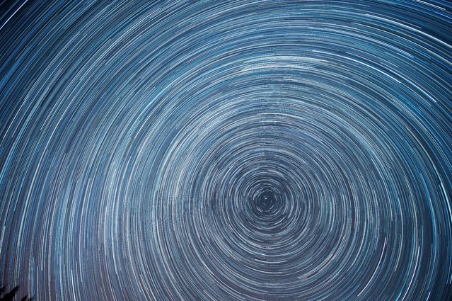 A composite photo made up of 356 images shows circumpolar stars during a draconid meteor shower taken from the village of La Hayuela, in Cantabria, northern Spain, early 10 October 2023. (Photo by Pedro Puente Hoyos/EPA)