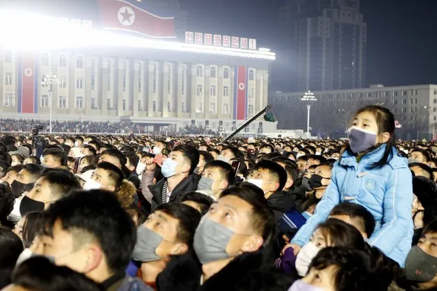People gather during national flag hoisting ceremony on Kim Il Sung Square in Pyongyang, North Korea, Saturday, January 1, 2022. (Photo by Cha Song Ho/AP Photo)