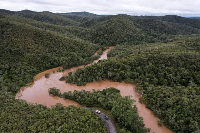 Cars stop before a flooded area, after Cyclone Batsirai made landfall, on a road in Vohiparara, Madagascar, February 6, 2022. (Photo by Christophe Van Der Perre/Reuters)