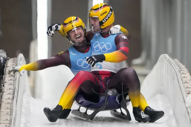 Tobias Wendl and Tobias Arlt, of Germany, celebrate winning the gold medal in luge doubles at the 2022 Winter Olympics, Wednesday, February 9, 2022, in the Yanqing district of Beijing. (Photo by Dmitri Lovetsky/AP Photo)