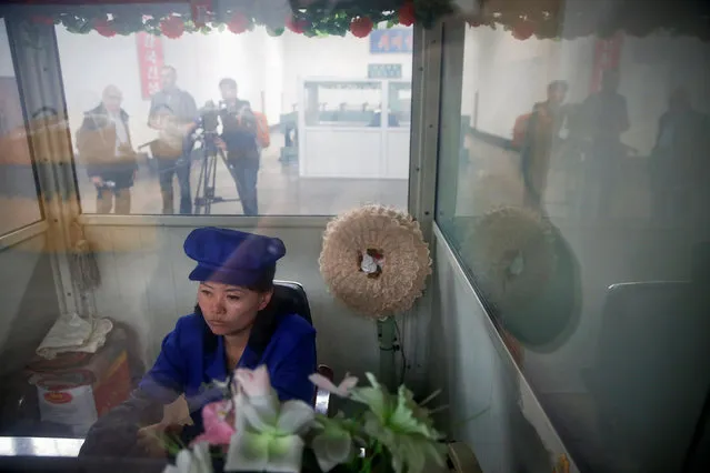A worker sits in a booth as foreign reporters film on a government organised tour to the Pyongyang 326 Electric Cable Factory in Pyongyang, North Korea May 6, 2016. (Photo by Damir Sagolj/Reuters)